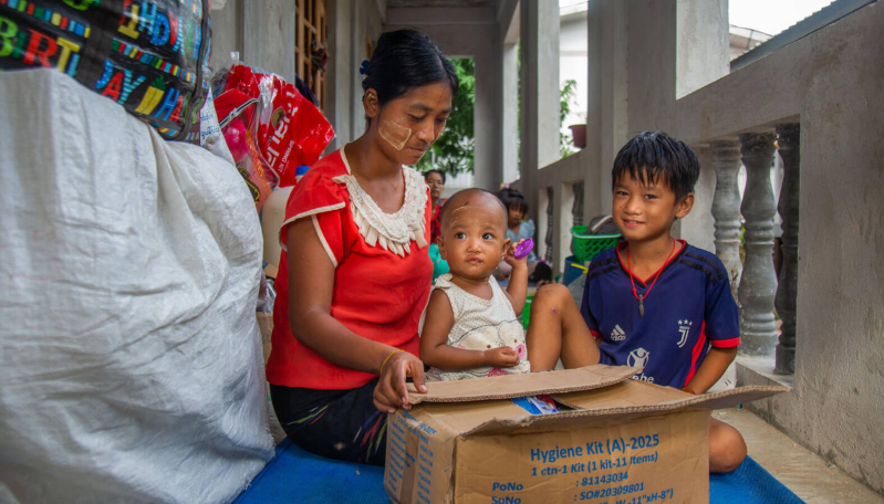 Ma Aye Su otwiera paczkę zawierającą materiały higieniczne